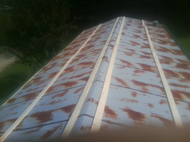 Rusted metal roof panels with new wood purlins before replacement — Storm Damage Roof Repair in Zionville by Roofing Brothers